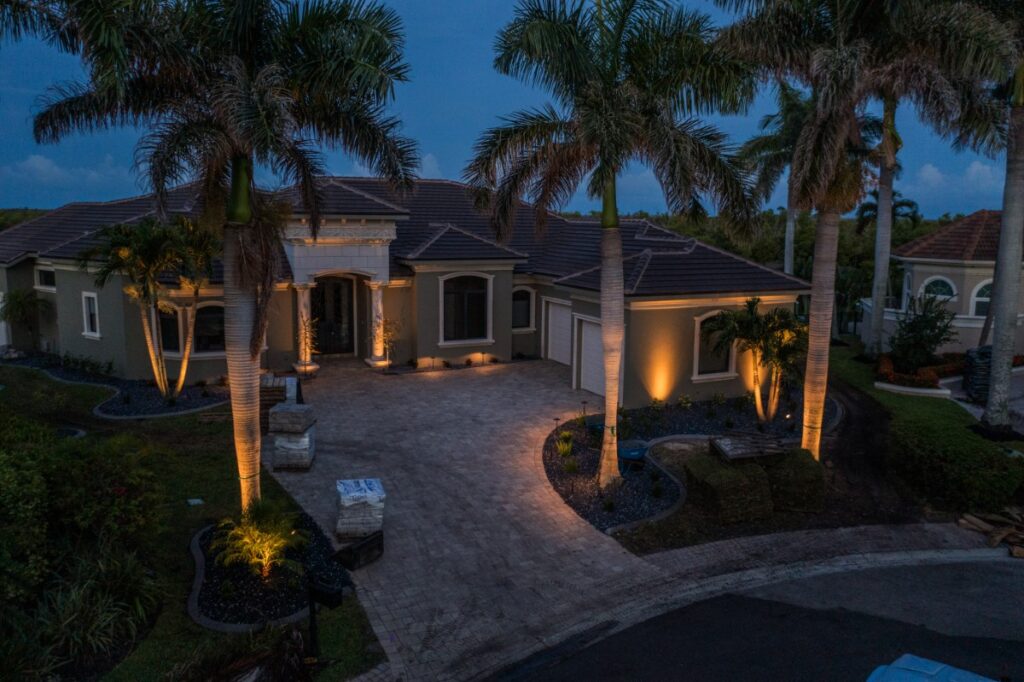Outdoor landscape lighting highlighting palm trees at night in Southwest Florida